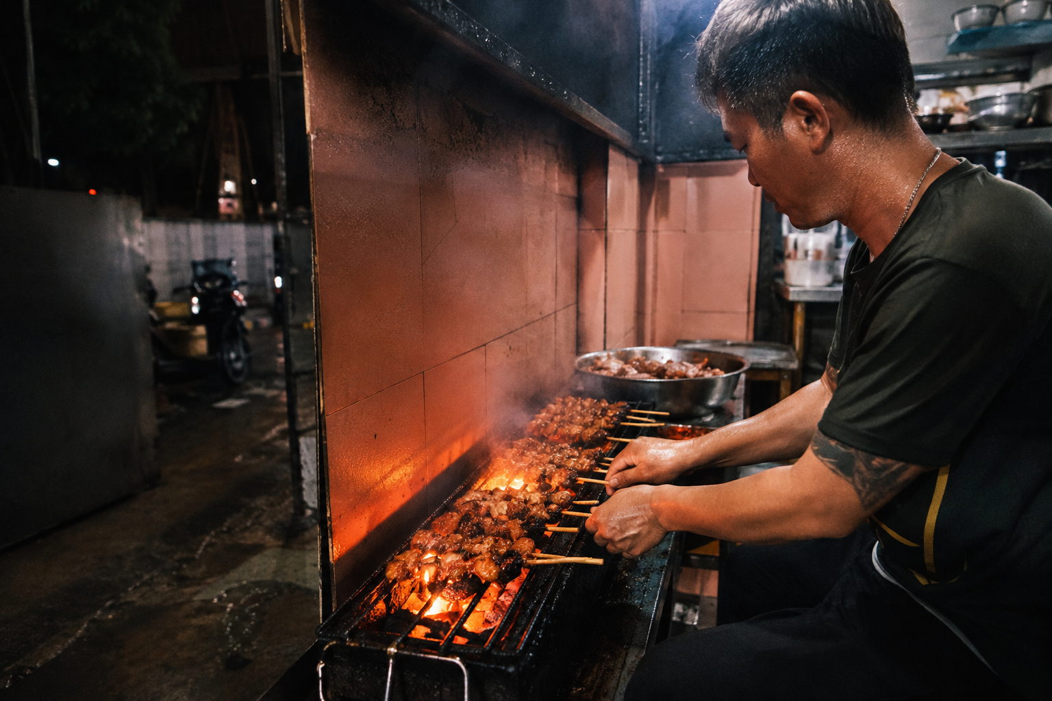 A cook grilling pork skewers over charcoal in Saigon